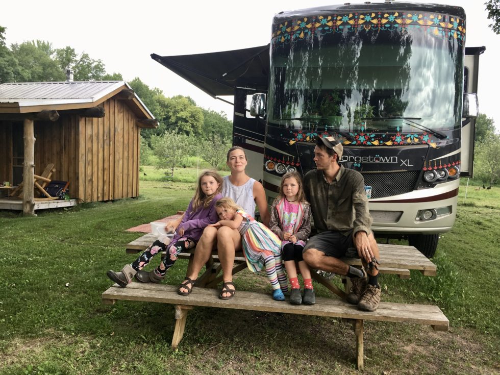 the family in front of their RV